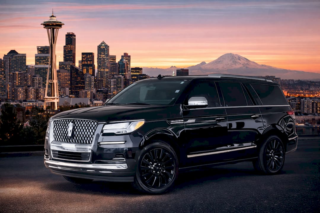 Seattle limo service with a black Lincoln Navigator, Space Needle, downtown skyline, and Mount Rainier